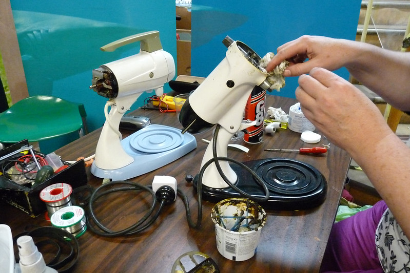 Image of a "Repair Cafe" fixing small appliances.